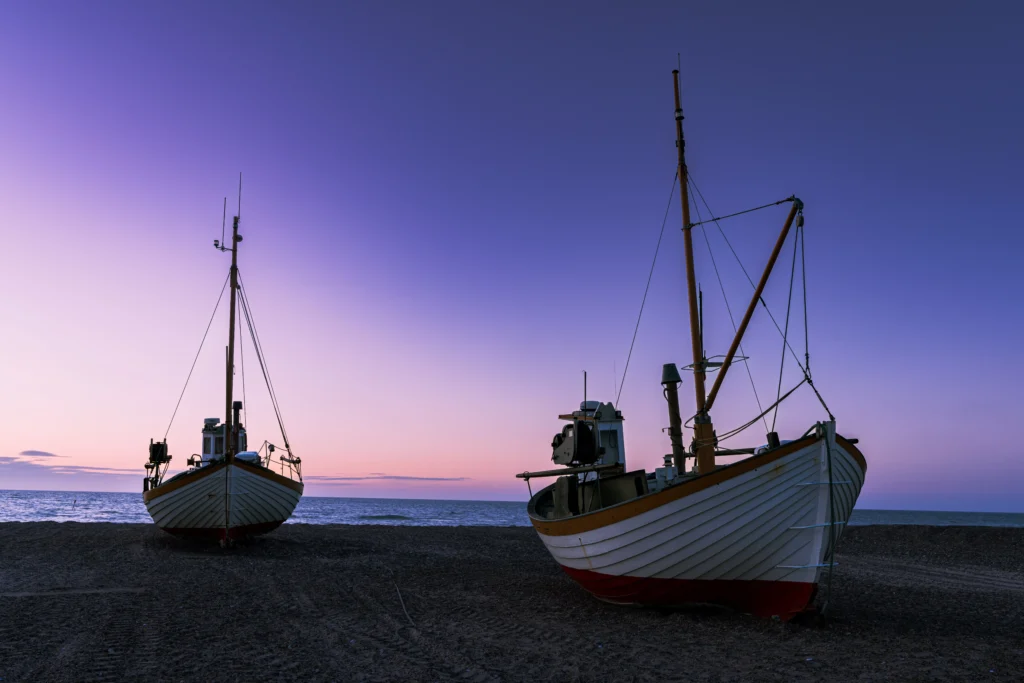 Traditional fishing boats at Slettestrand beach in Denmark at sunset